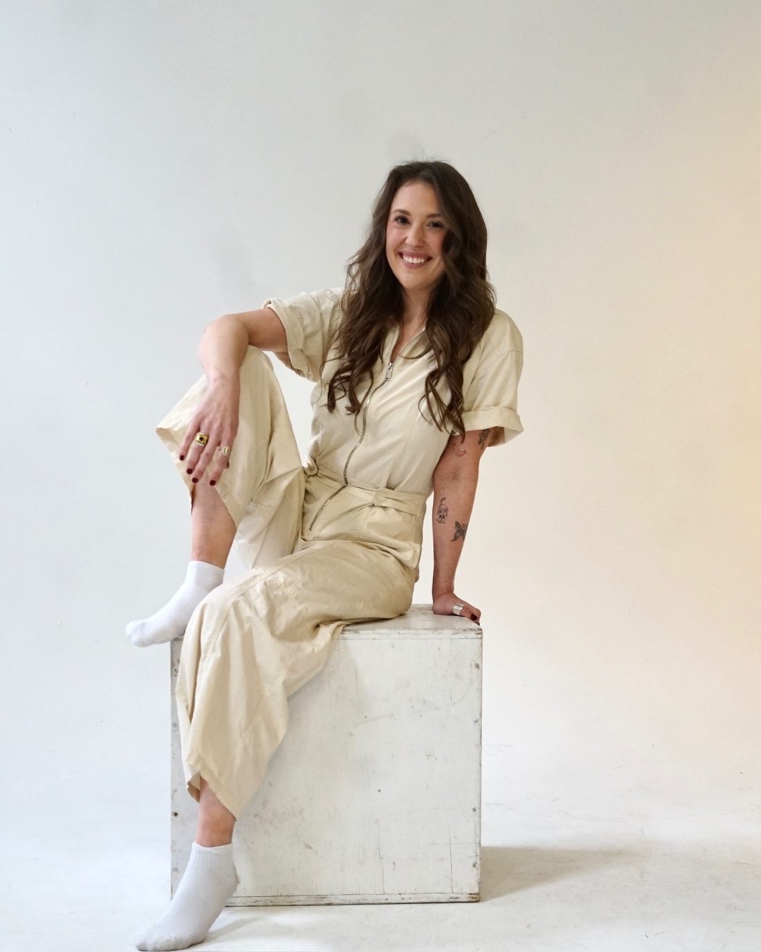 Alise McCreary seated on a block, smiling