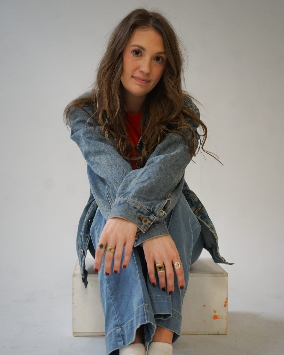 Alise McCreary, founder of Studio Jam, seated in a denim jacket